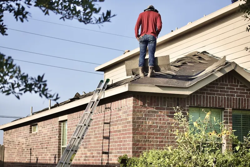 Professional roofer working on a residential roof in Bagley